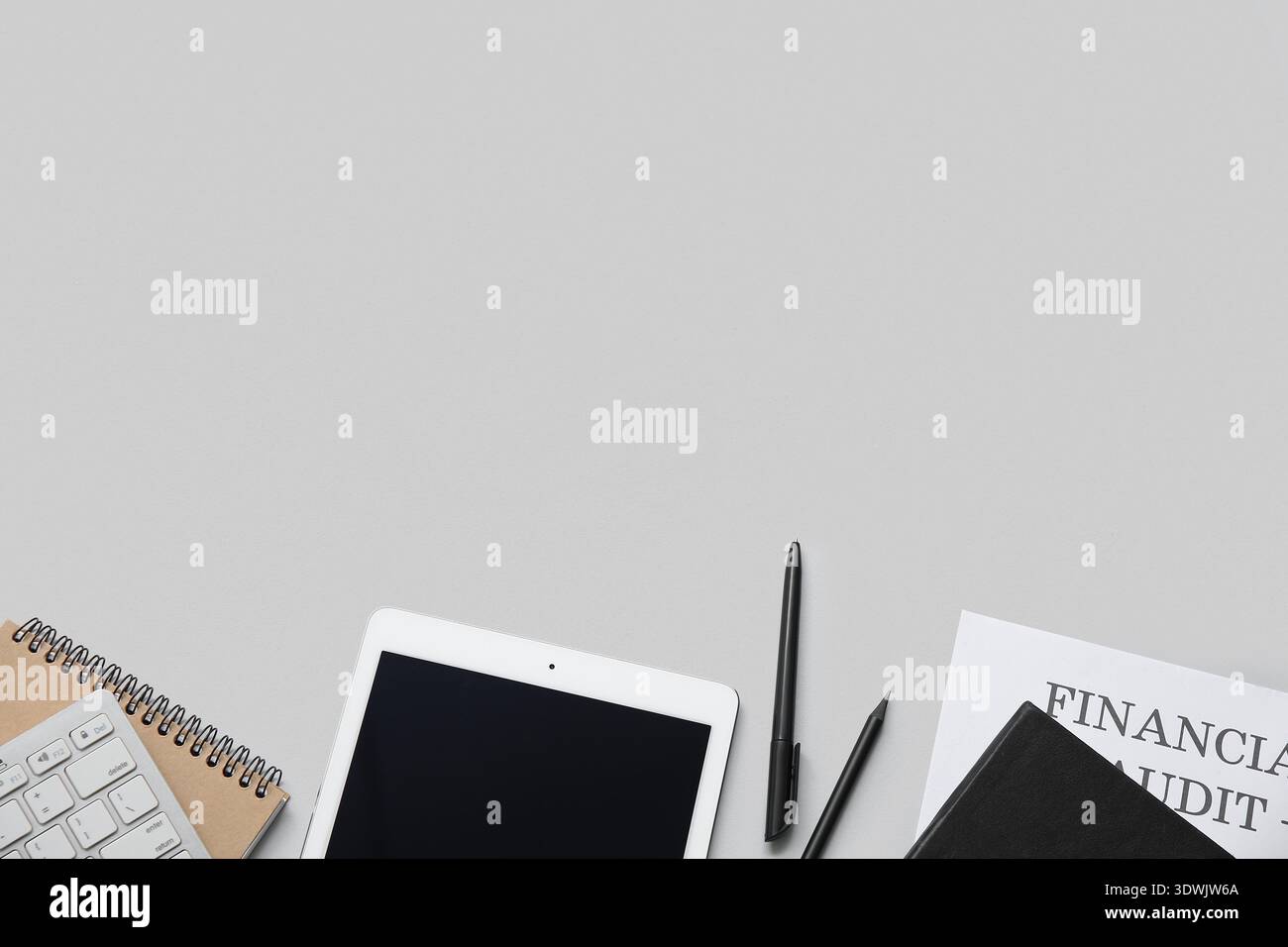 Composition with modern tablet computer and stationery on grey background Stock Photo
