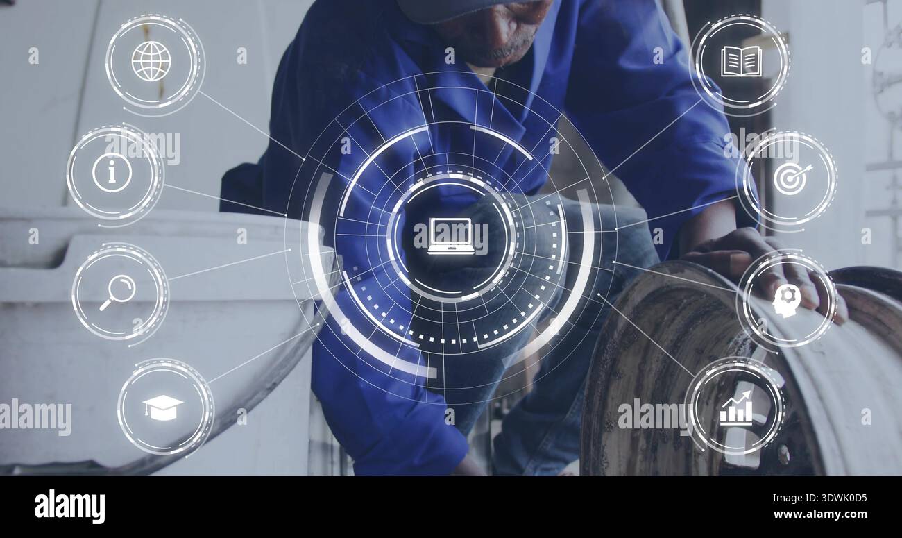 Crouching tech in blue shirt and cap inspecting drum, white tank at workshop, with HUD overlay Stock Photo