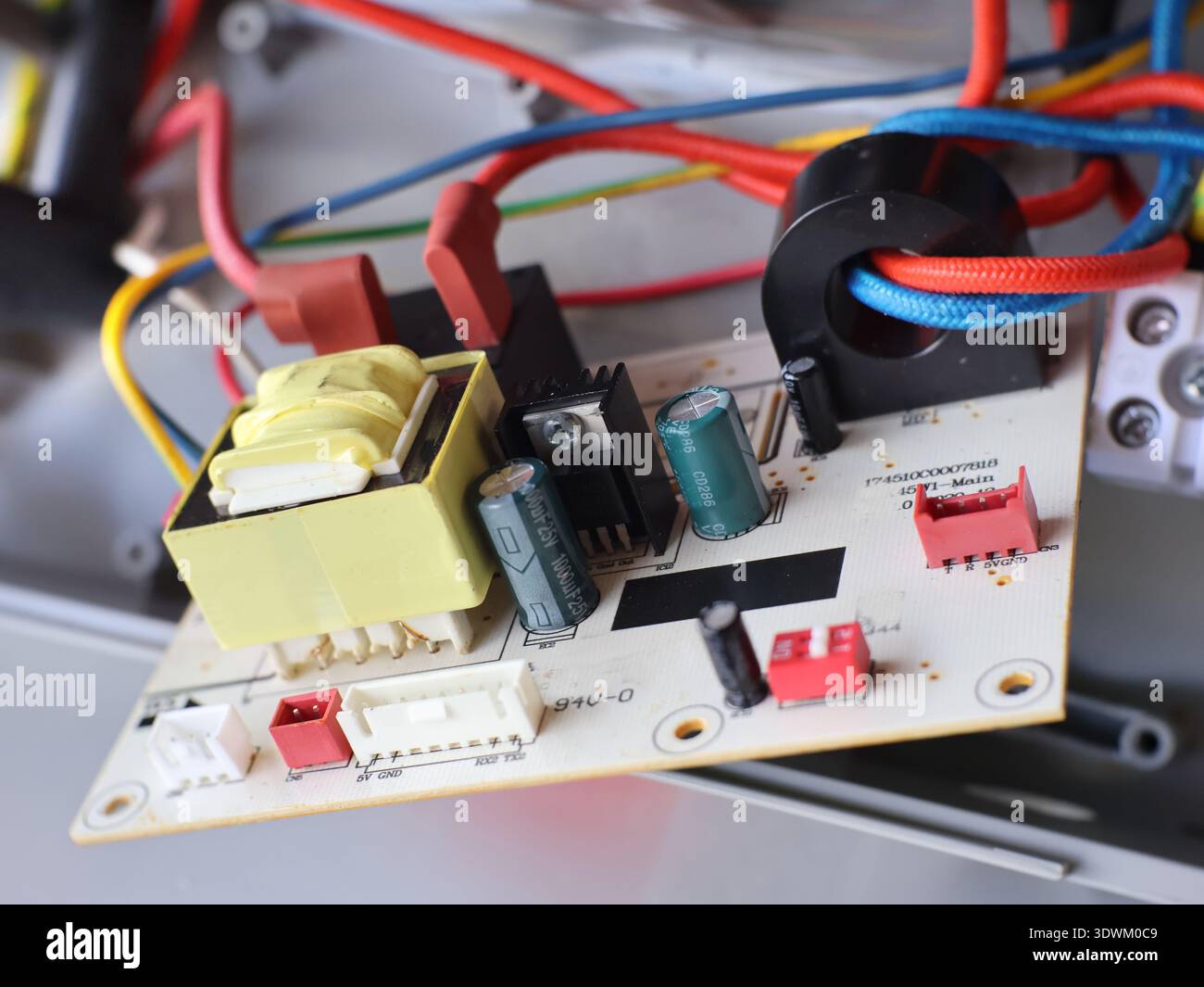 Image of a printed circuit board (PCB) containing various electronic components. Stock Photo
