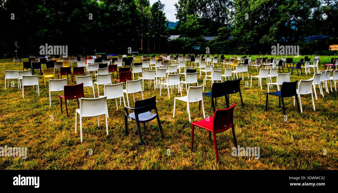 set of colorful chairs on green lawn during the Lago Film Festival in Revine Lago Treviso Veneto Italy Stock Photo