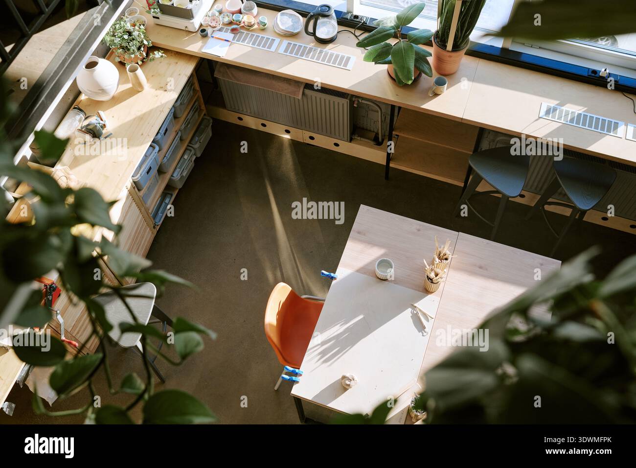Empty Creative Workspace with Sunlight Illuminating Modern Art Supplies Stock Photo
