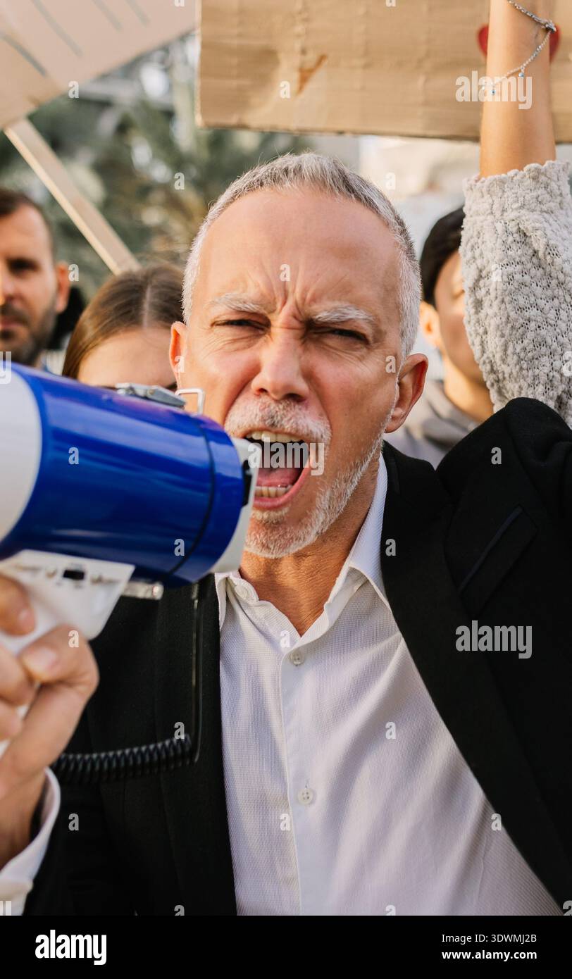 Mature man activist protesting for climate change with megaphone Stock Photo