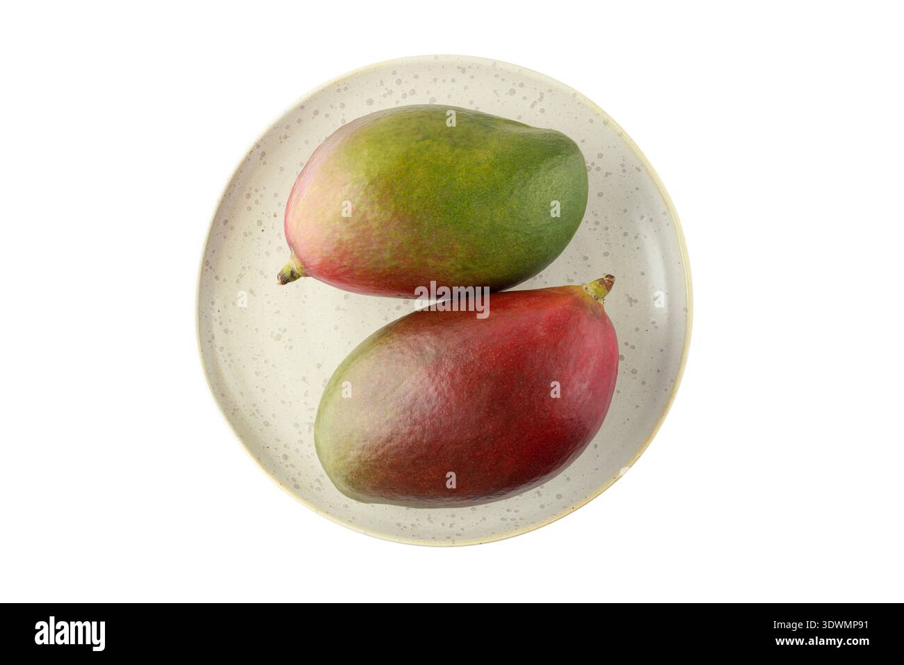 Two whole ripe mango Palmer fruits on retro plate isolated on white background. Stock Photo