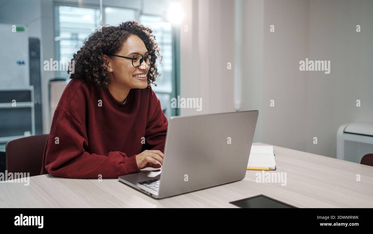 Woman Engaged In Collaborative UX Design Process Using Wireframes And Sticky Notes In Workspace Stock Photo