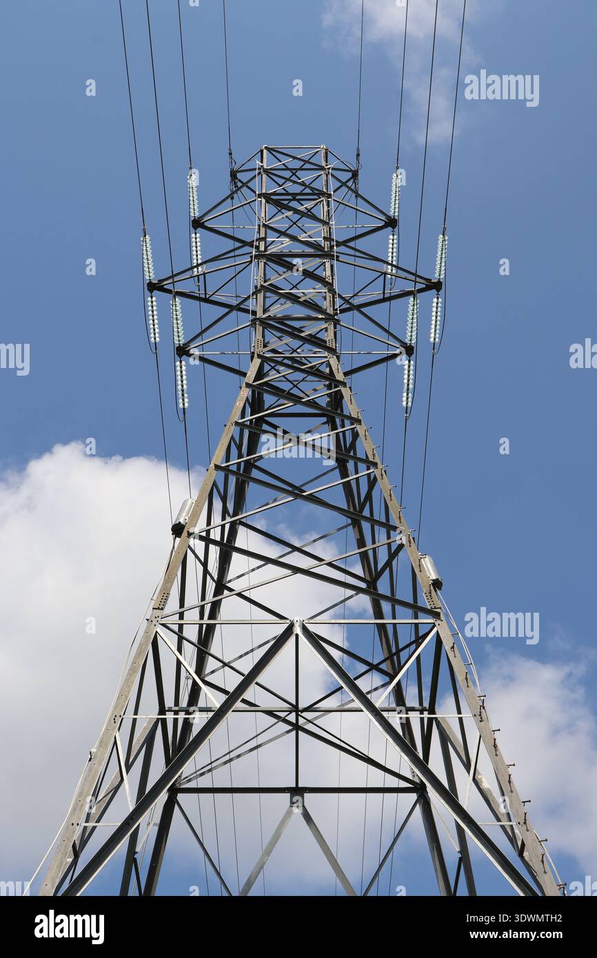 Electric transmission tower in front of cloudy sky Stock Photo