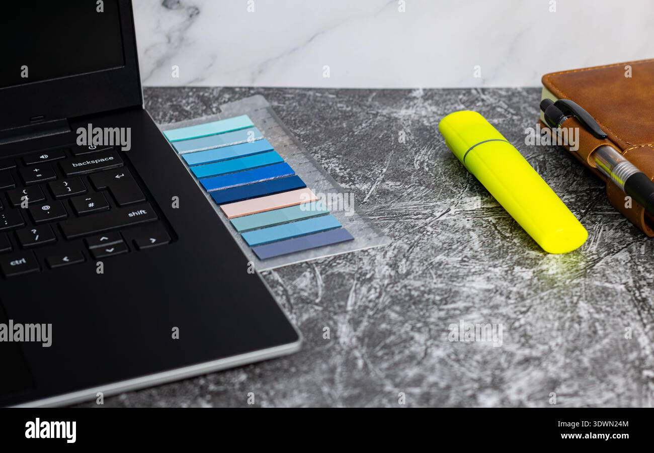 Image of laptop, notepad and highlight marker Stock Photo