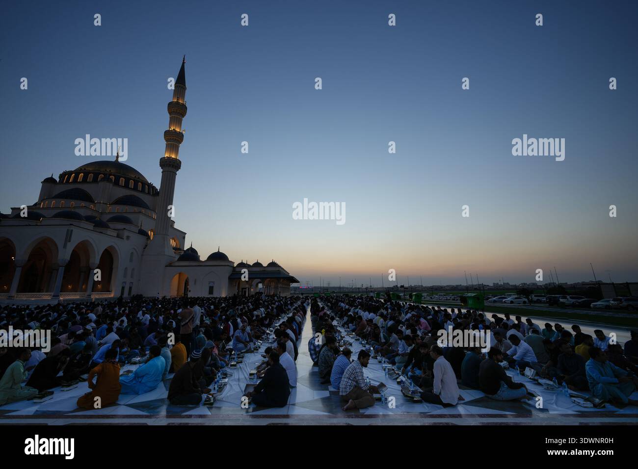 Muslim devotees wait before starting Iftar, the meal that breaks the ...