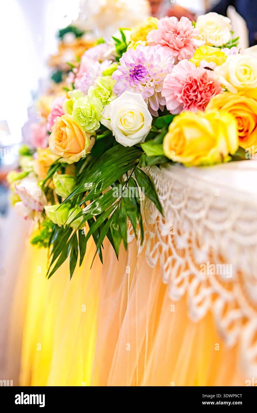 Festive flower composition on the yellow background. Overhead view Stock Photo