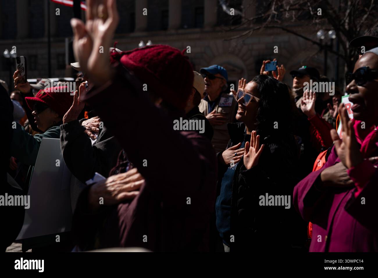 Recite Mark Former USAID staff and supporters recite an oath of office during a ...
