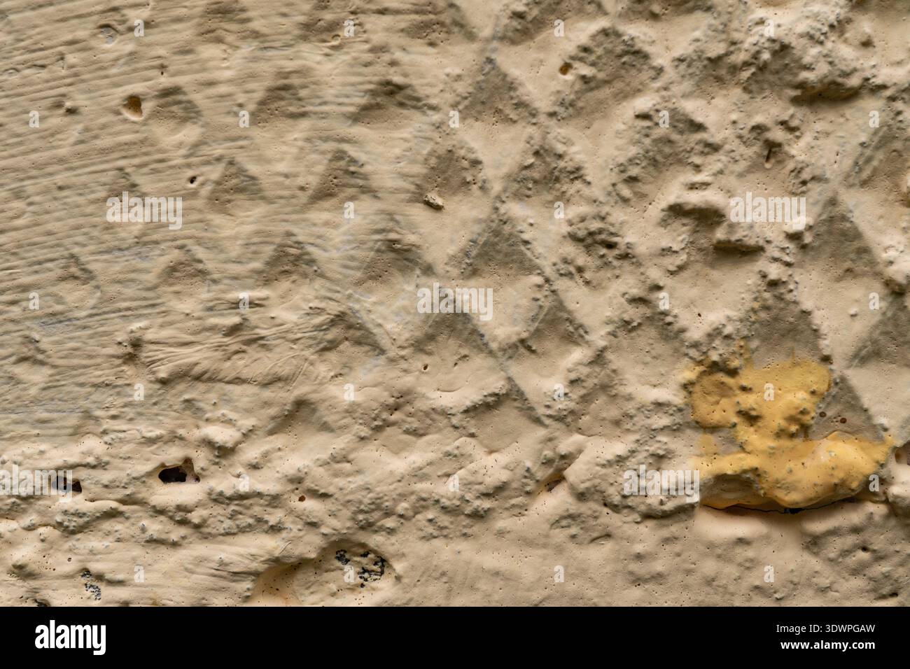 Textured beige wall with diamond pattern and subtle color variations Stock Photo