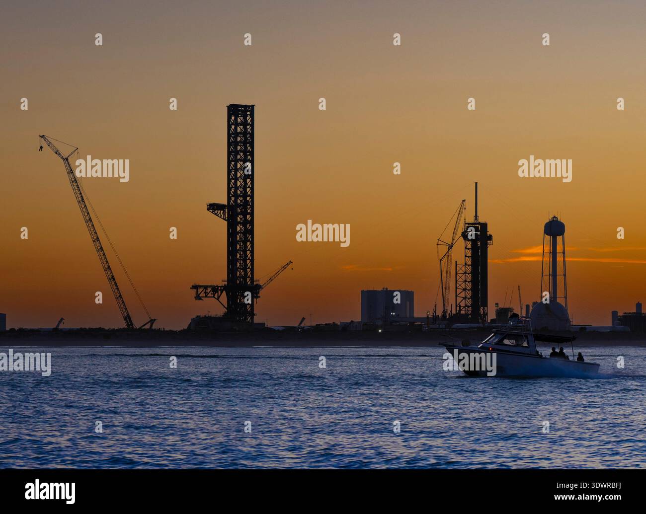 The sun sets behind SpaceX's Starship tower at Launch Complex 39A (LC-39A) at Kennedy Space Center in February, 2026 Stock Photo