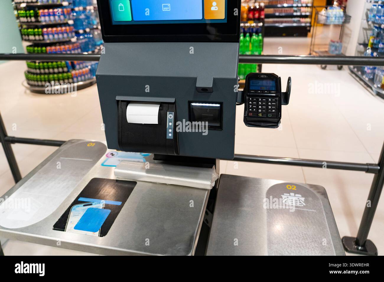 Self checkout terminal in a supermarket with payment card reader and ...