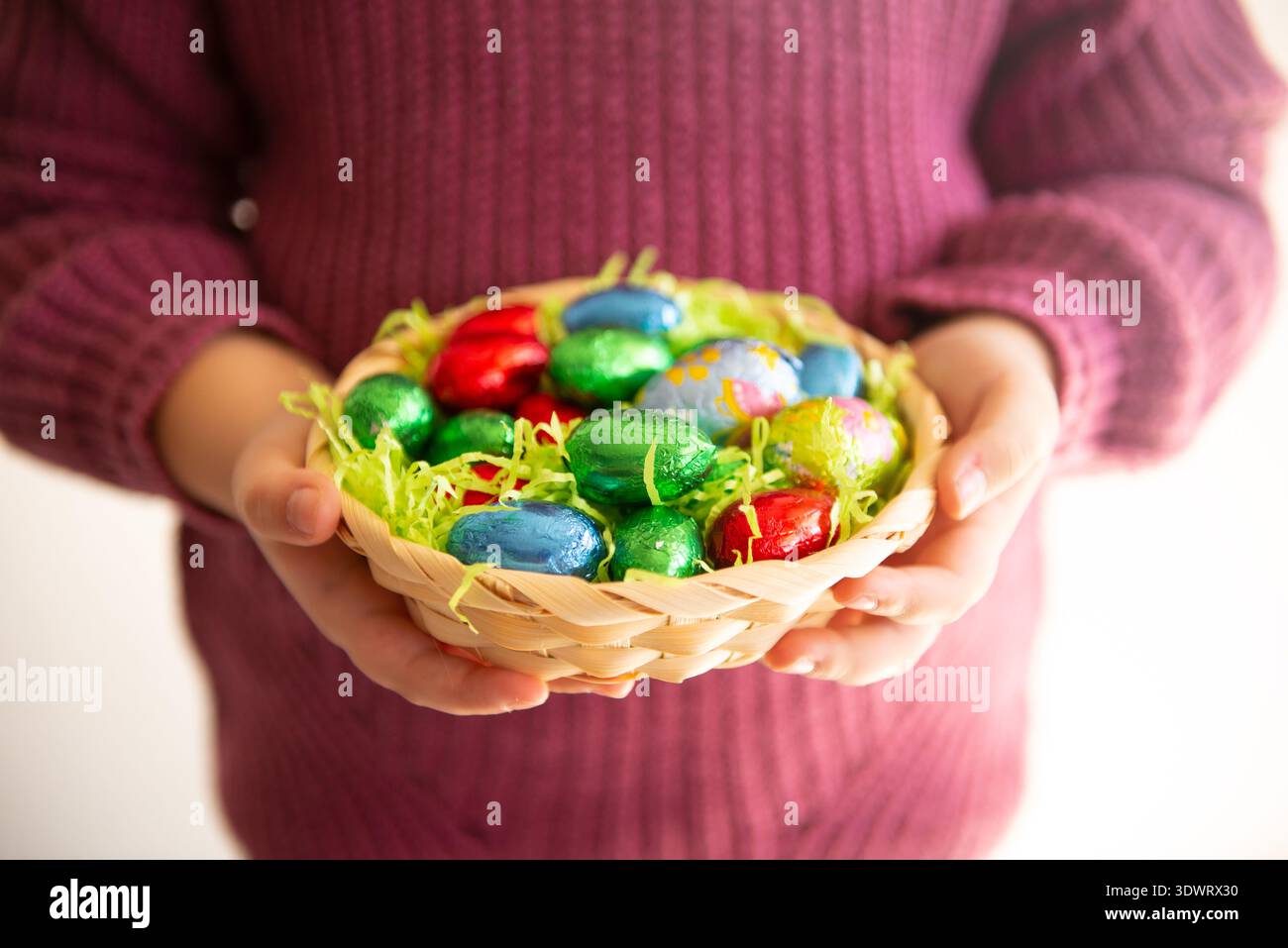 Basket with chocolate colored eggs Easter decor Stock Photo