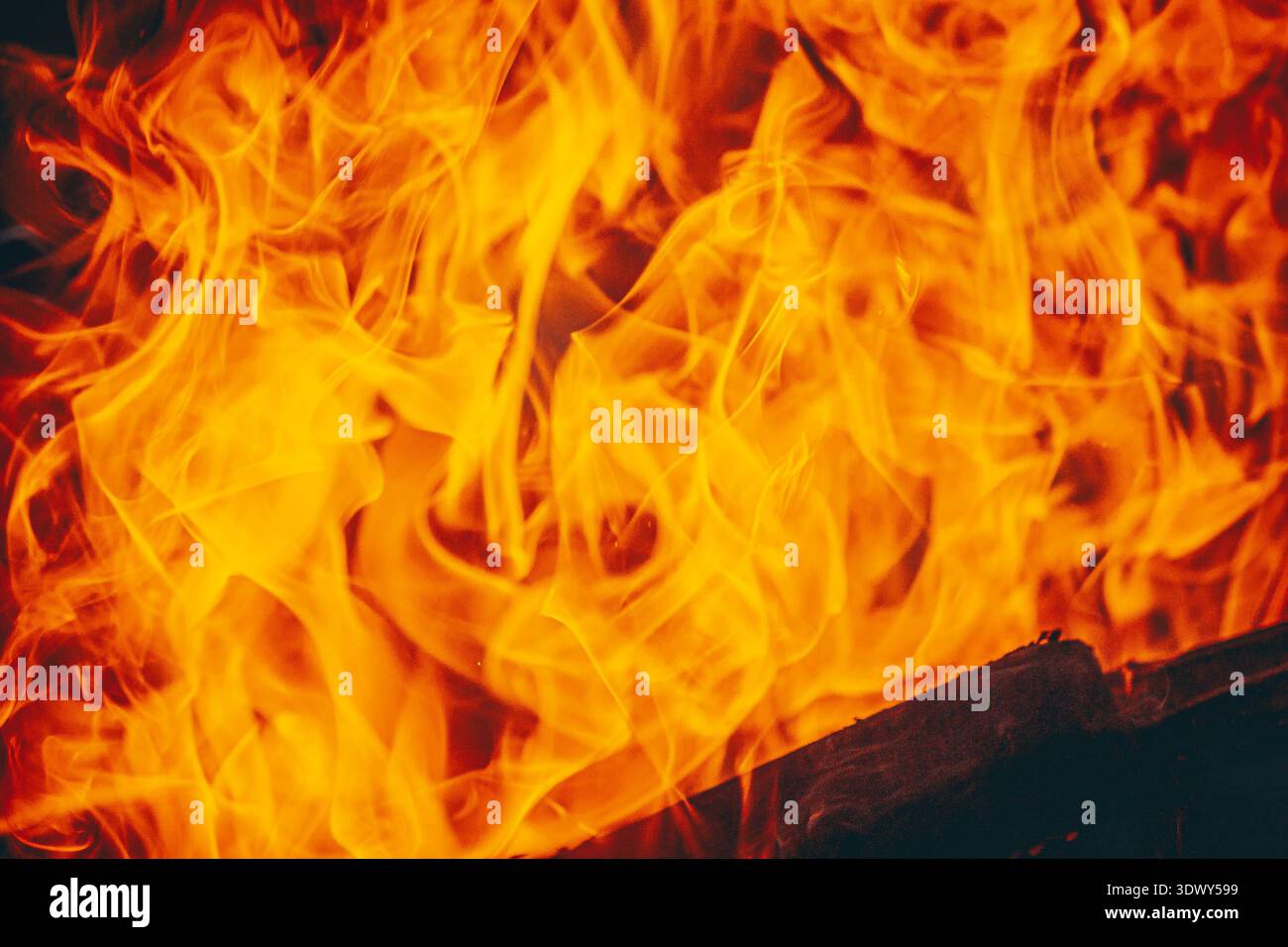Bright fire flames close-up abstract burning background texture Stock Photo