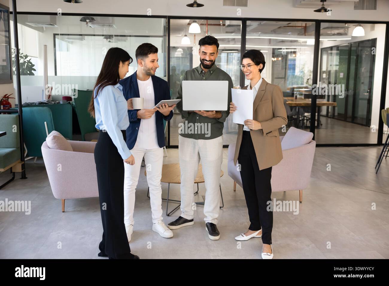 Smiling team members discussing project in office Stock Photo