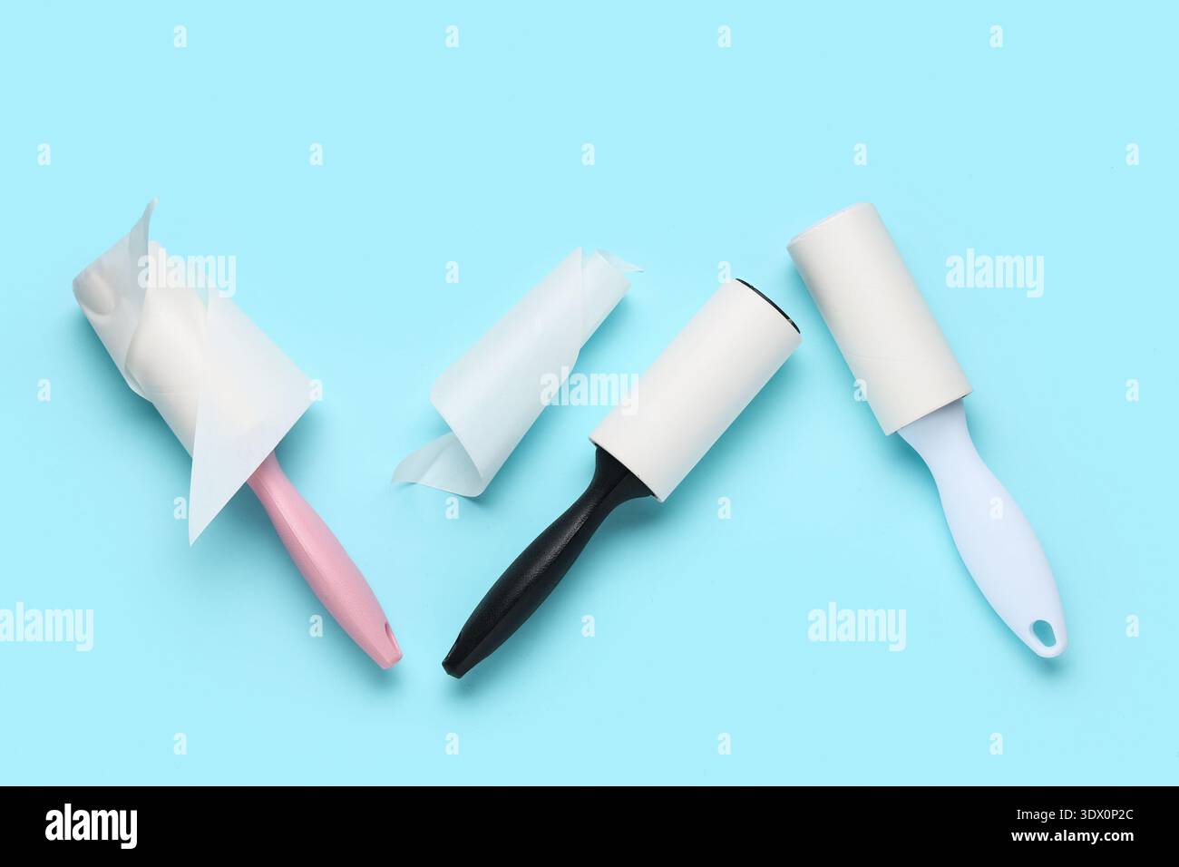 Sticky lint rollers on blue background Stock Photo