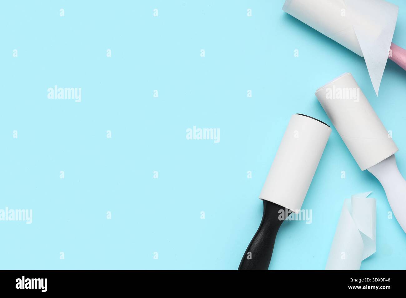 Sticky lint rollers on blue background Stock Photo