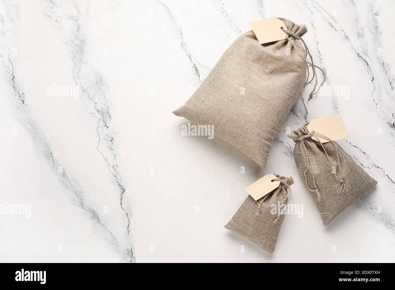Full sacks with tags on grunge white background Stock Photo