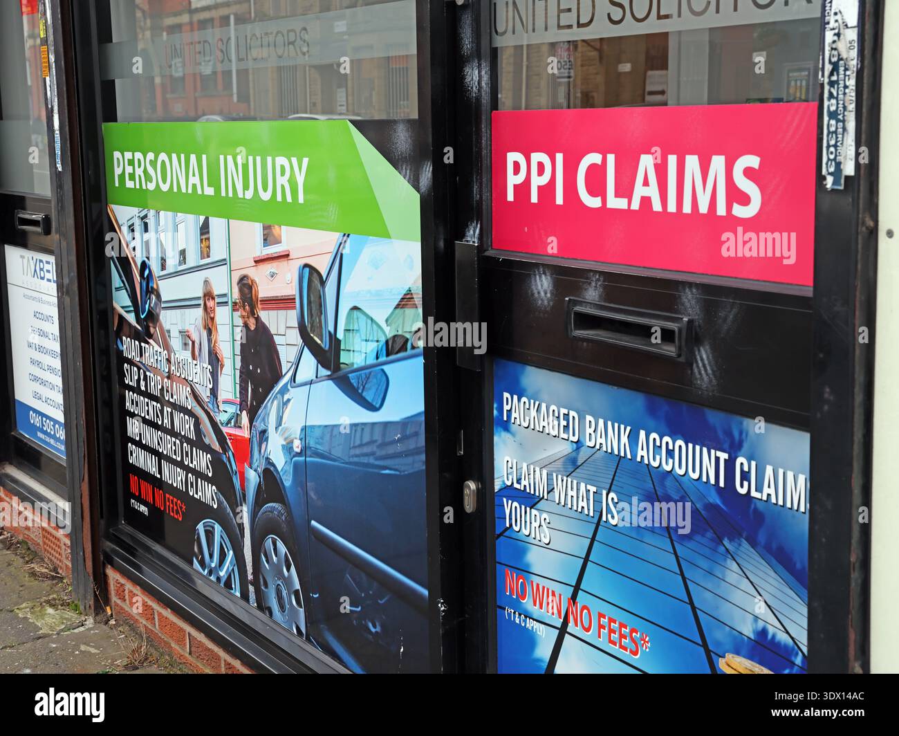 Shopfront window advertising PPI claims, personal injury and packaged bank account claims at a solicitors office in Manchester, England. Stock Photo