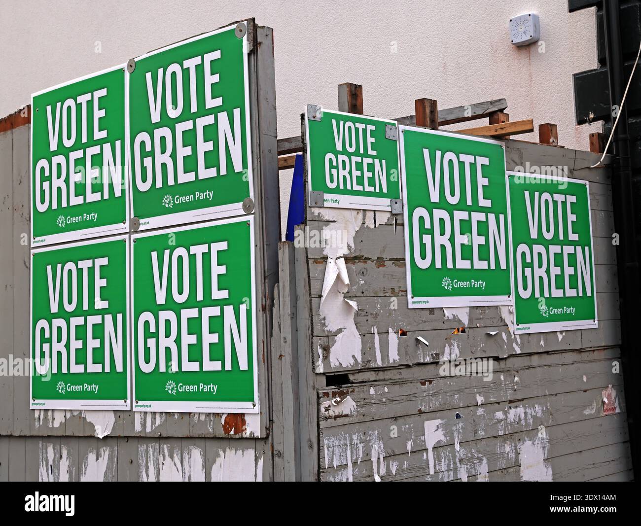 Green Party “Vote Green” campaign posters mounted on a roadside hoarding on Stockport Road in Levenshulme, Manchester, England. Stock Photo