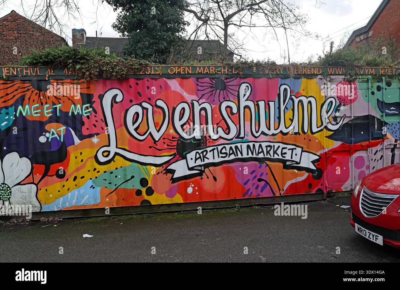 Colourful Levenshulme Artisan Market mural and opening information painted on a car park container off Stockport Road in Levenshulme, Manchester. Stock Photo