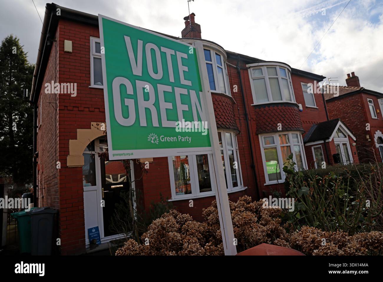 Vote Green garden sign outside a semi-detached middle-class home in Gorton, Manchester, England, UK, showing street level political campaigning. Stock Photo