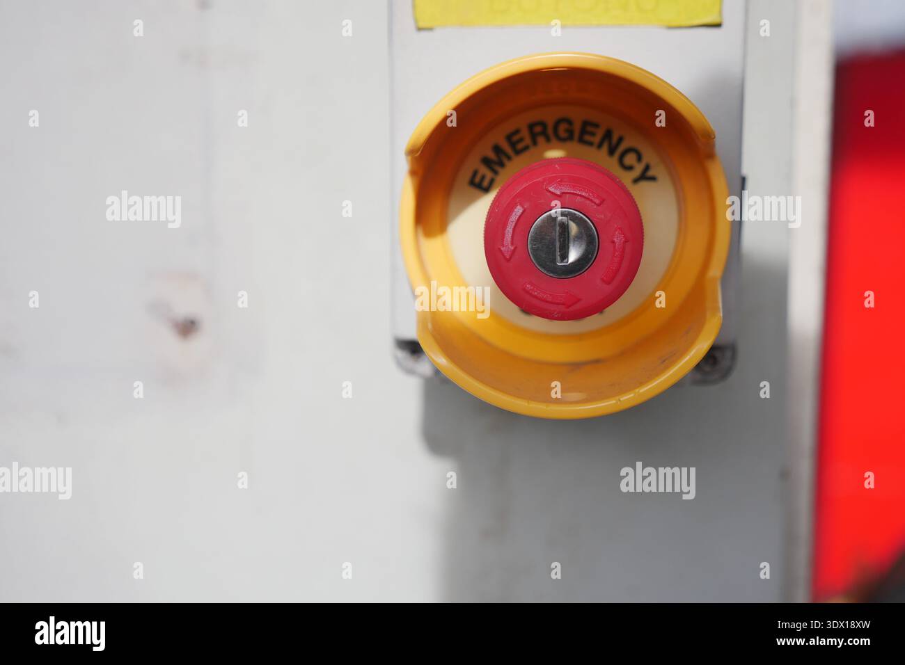 Emergency button on equipment in a workspace area Stock Photo