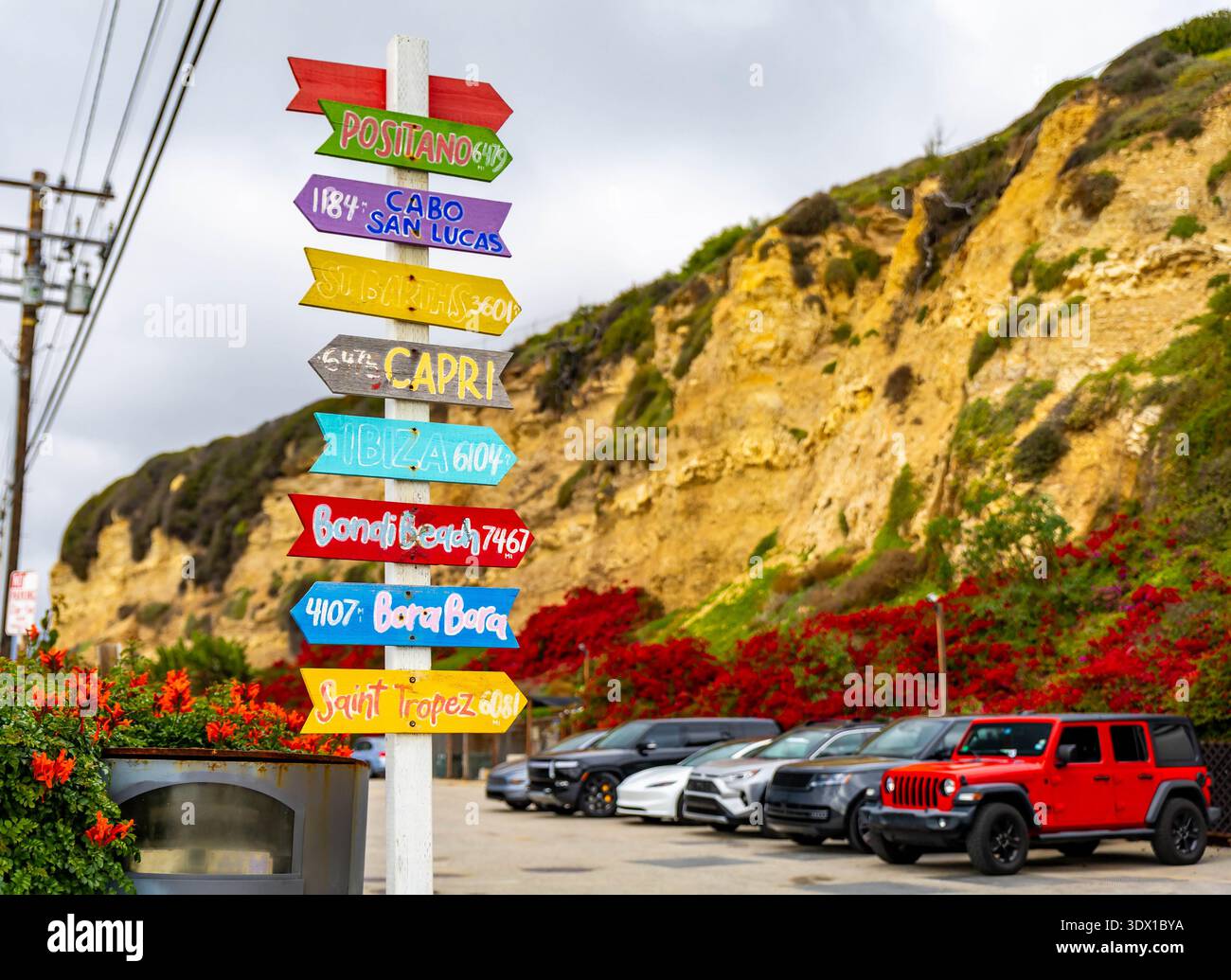 Colorful destination direction signs at Point Dume sand beach in ...