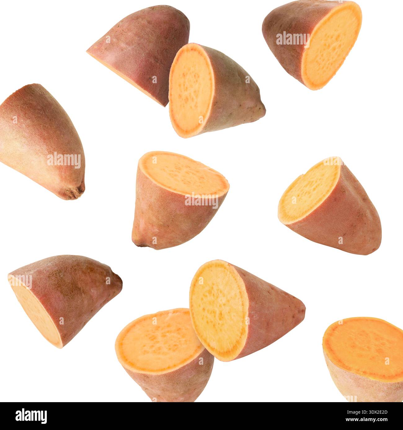 Sweet potato pieces falling against white background Stock Photo