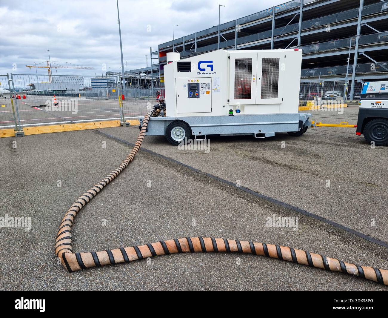 Ground support equipment Guinault air start unit ASU GS180 or GS280 (comprising a compressor) with connection tube on platform of Eindhoven Airport - Smartphone Captured Stock Image