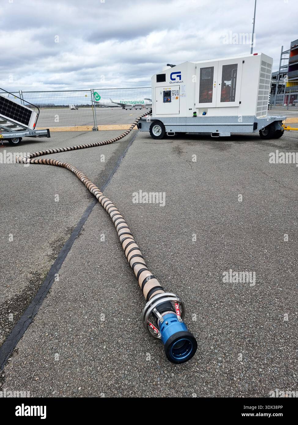 Ground support equipment Guinault air start unit ASU GS180 or GS280 (comprising a compressor) with connection tube on platform of Eindhoven Airport - Smartphone Captured Stock Image