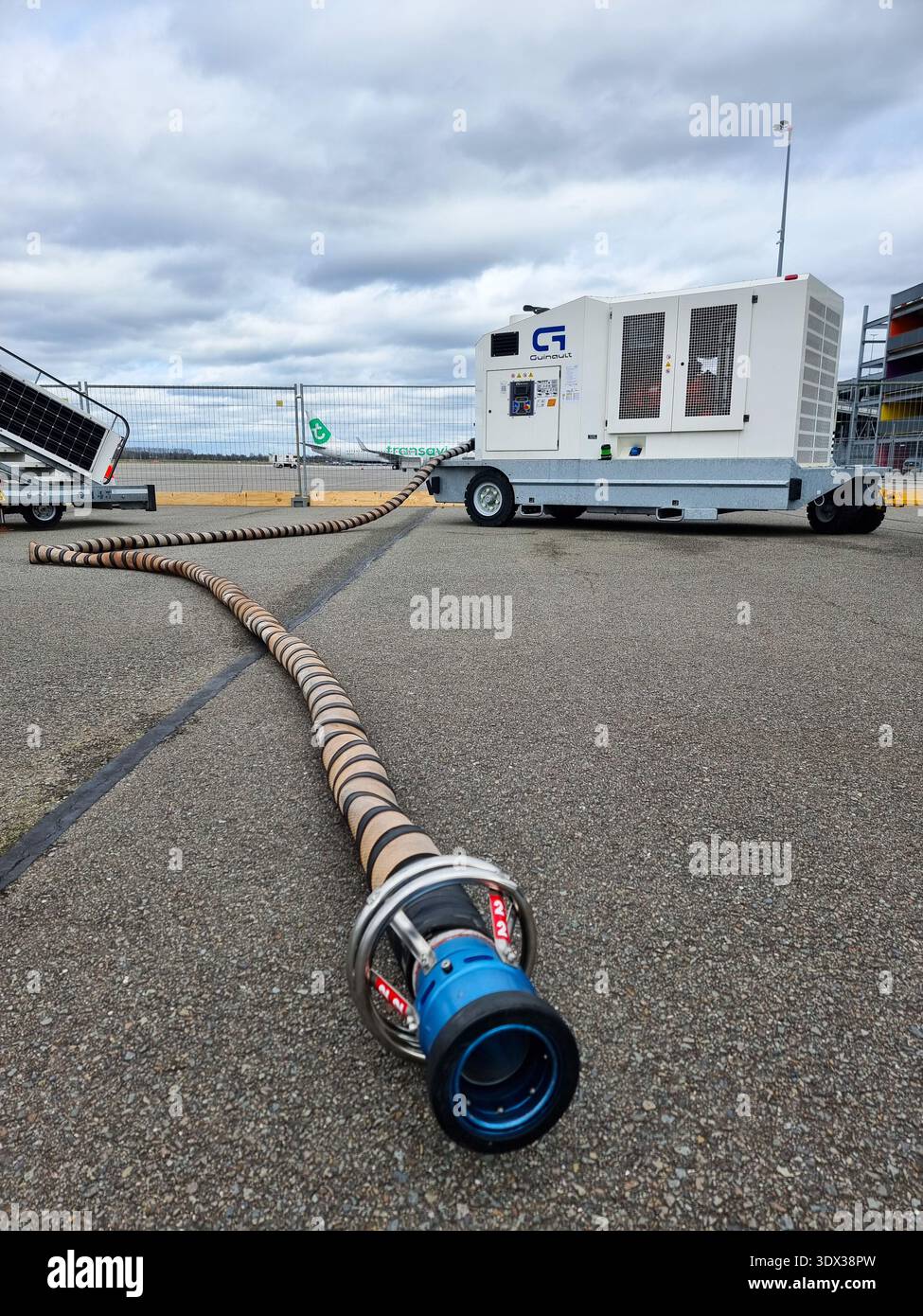 Ground support equipment Guinault air start unit ASU GS180 or GS280 (comprising a compressor) with connection tube on platform of Eindhoven Airport - Smartphone Captured Stock Image