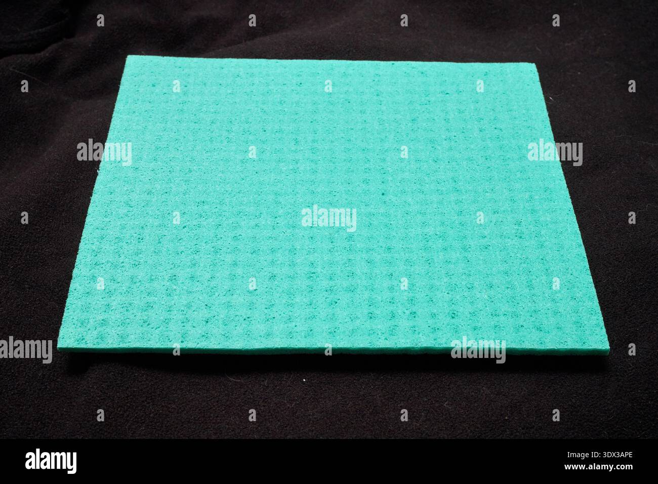 green micro-fiber sponge on a black background Stock Photo