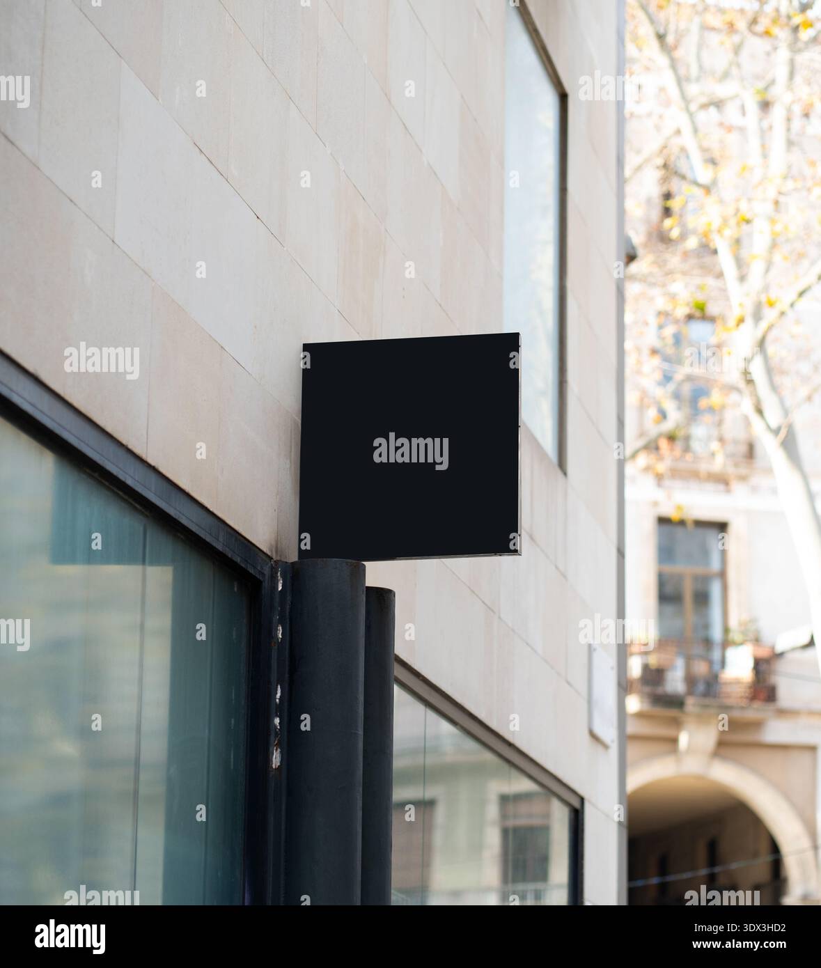 Black rectangular mockup signboard hanging on classic building wall Stock Photo