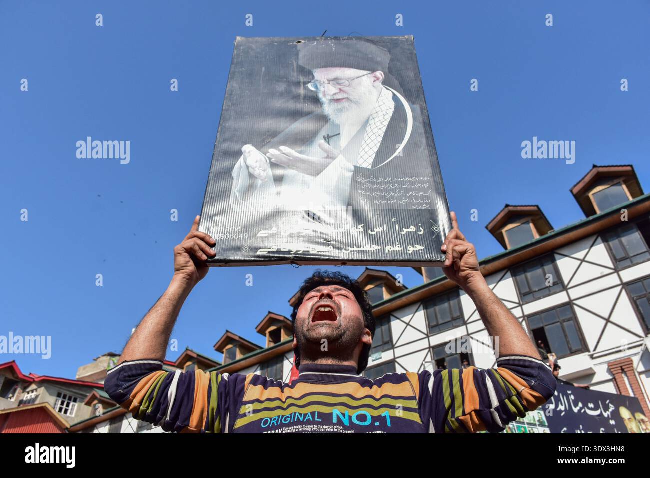 A Kashmiri Shiite Muslim mourns as he holds a photograph of the ...