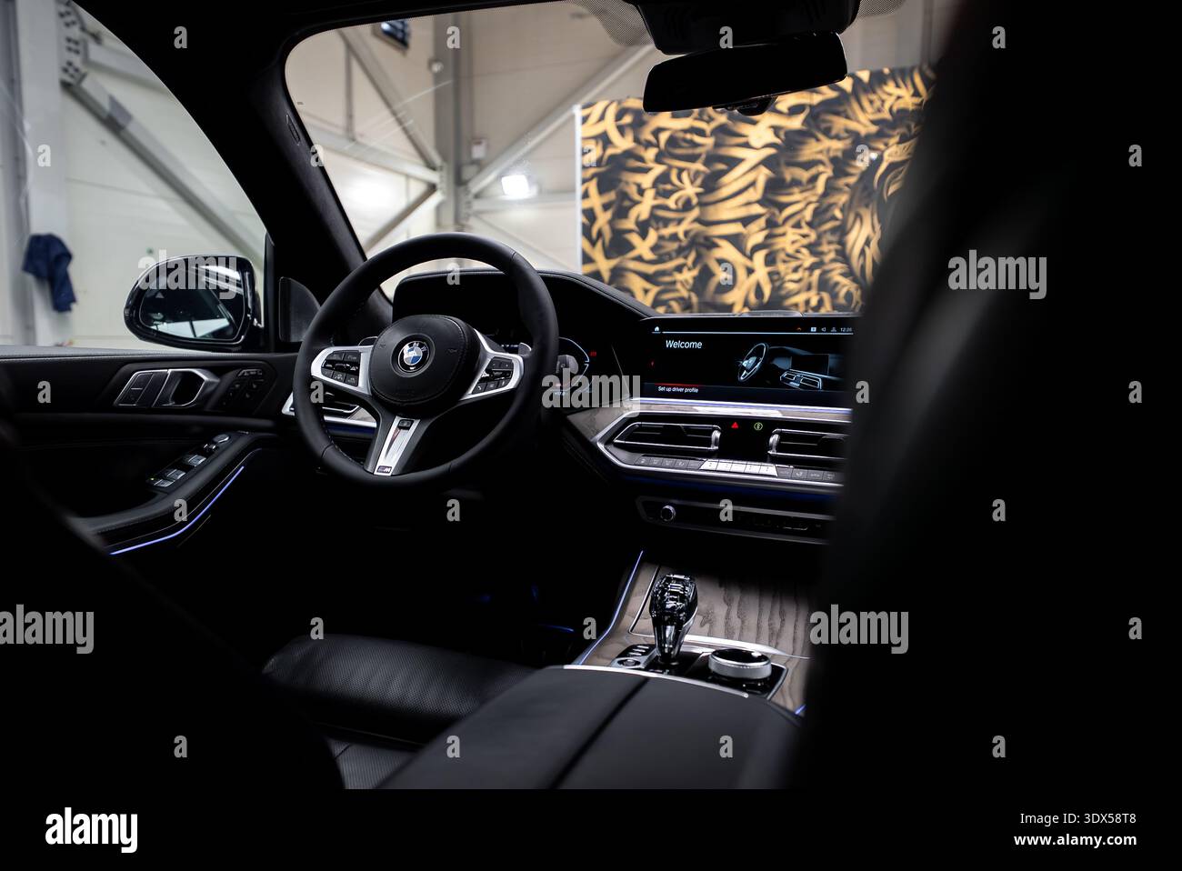 BMW X7 cockpit with leather wheel, crystal shifter, and welcome screen Stock Photo