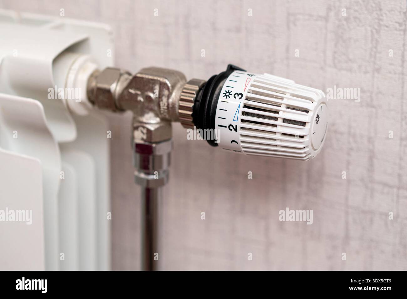 House Radiator Knob A detailed view of a manual thermostat knob on a home radiator used for ...