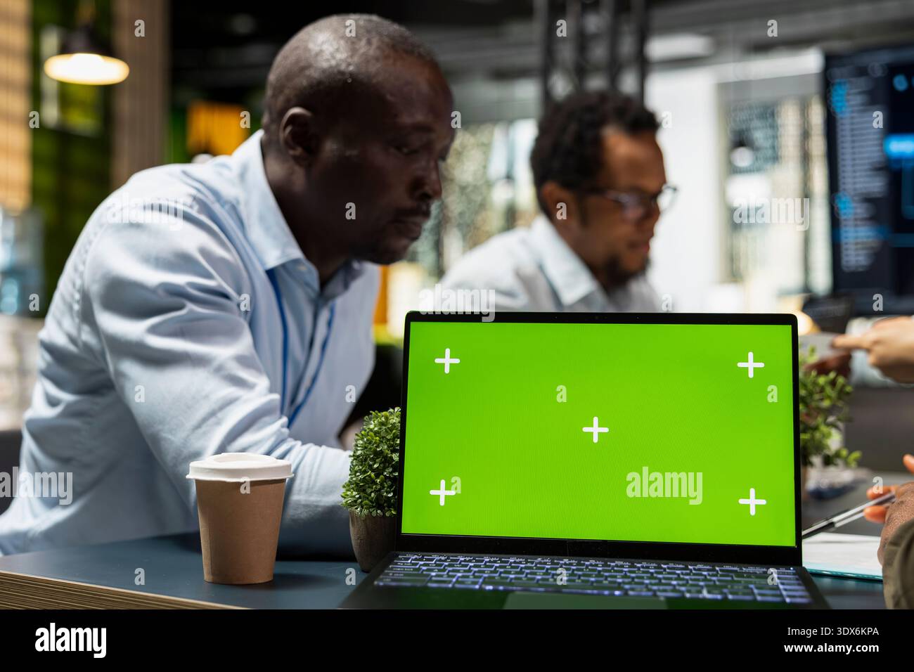Green screen laptop used by programmers in Silicon Valley company office developing software apps. Mockup notebook used by IT professionals at work to code, debugging applications to resolve issues Stock Photo