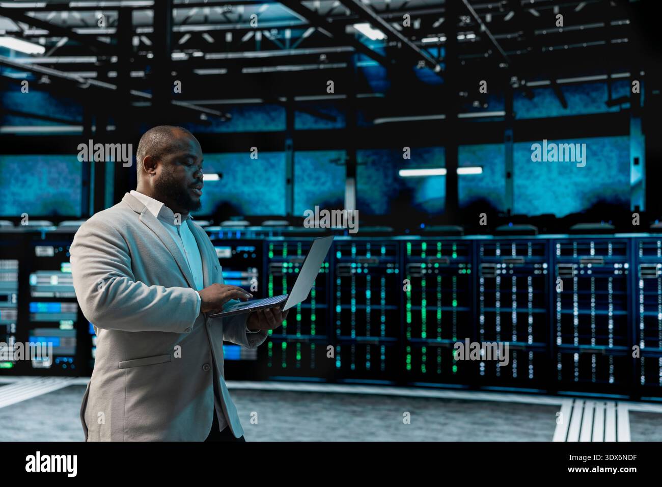Data center software developer using laptop to protect servers from exploitable software vulnerabilities, auditing systems. African american server farm employee looking for bugs slowing down rigs Stock Photo