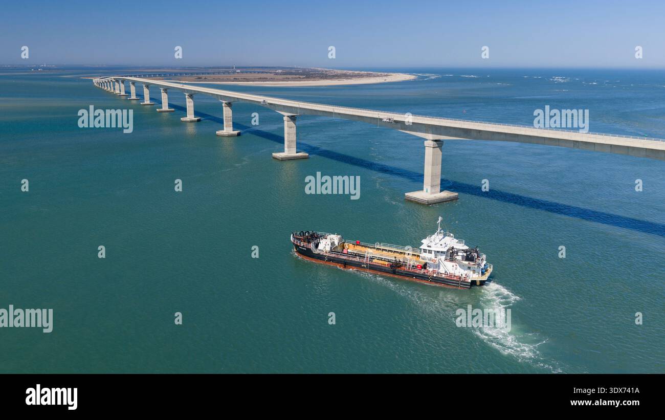 A dredge passes by the new Marc Basnight Bridge replaced the old ...