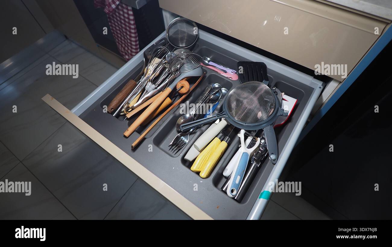 Kitchen drawer with various cooking tools and utensils Stock Photo