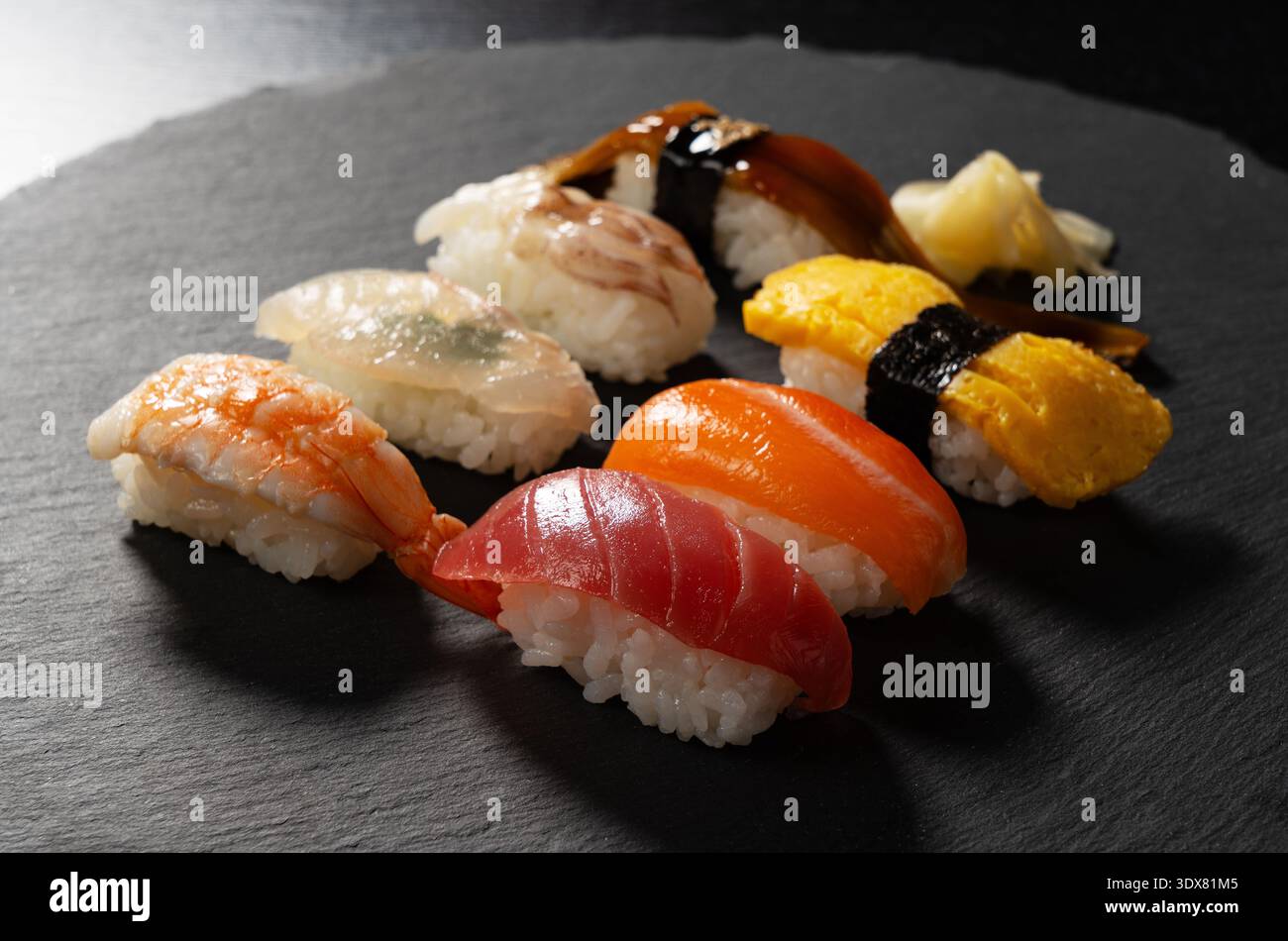 Assorted traditional Japanese nigiri sushi set on a dark slate plate Stock Photo