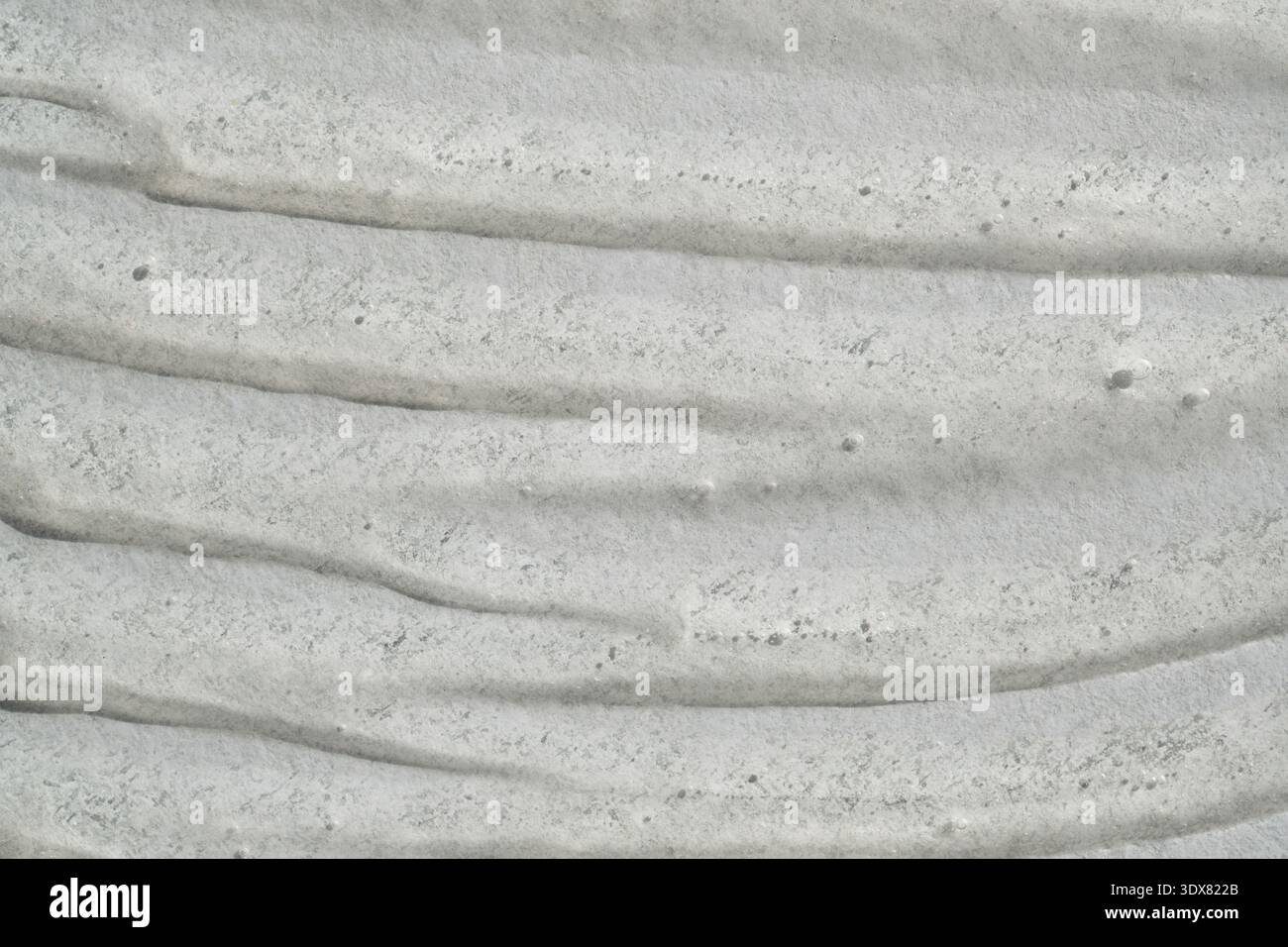 Gray textured surface with rugged, uneven, wavy patterns and gritty ...