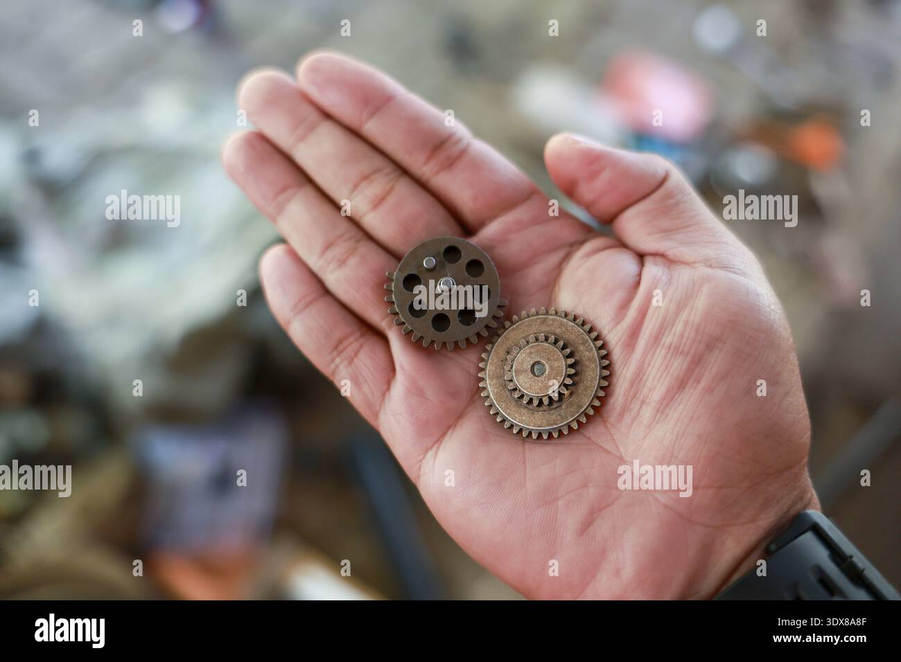 Thoughtful mechanic hand holding two old metal gear cogs. close up of  vintage machine part, representing precision, industrial engineering and  teamwor Stock Photo - Alamy