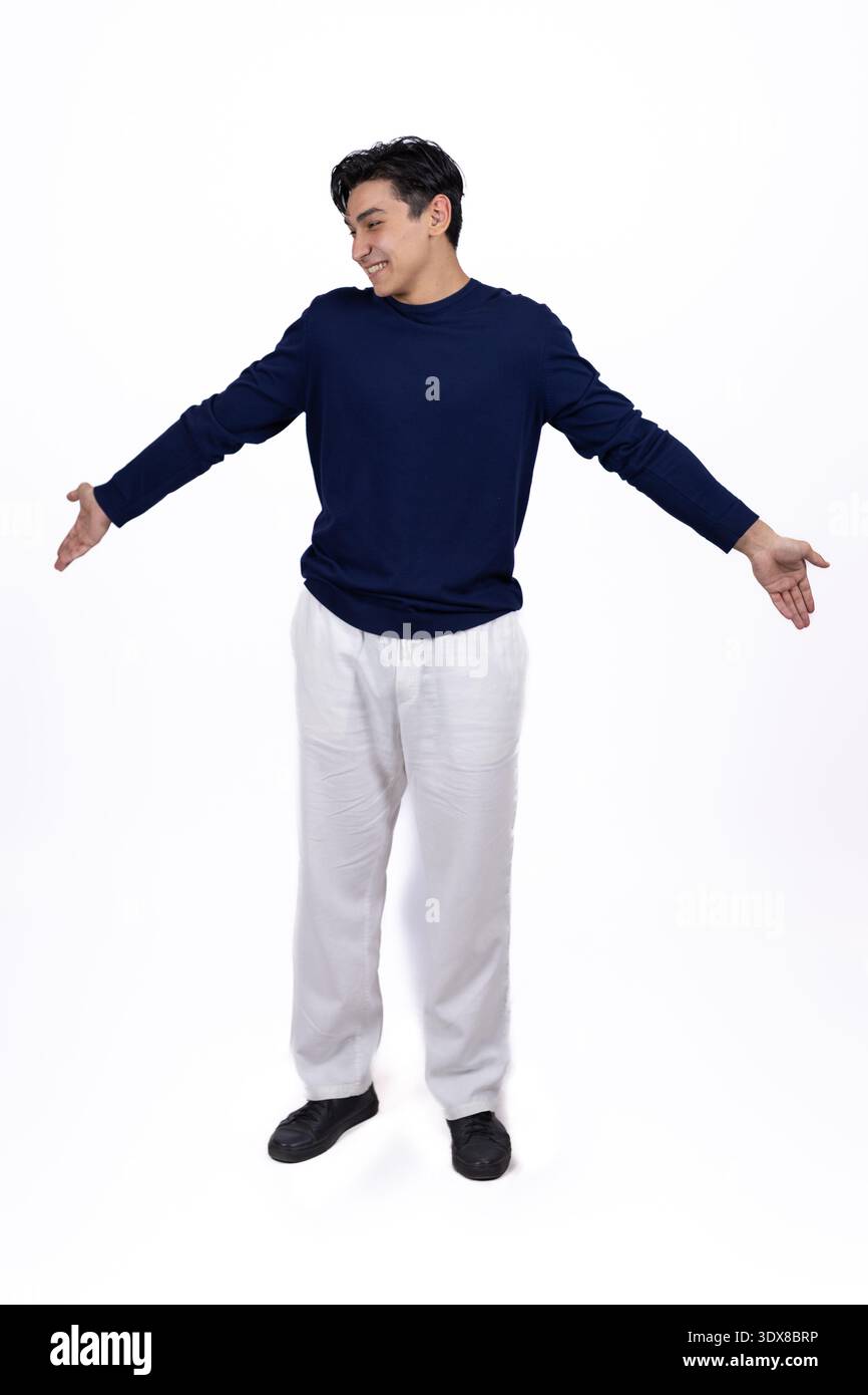 Young man spreading hands in a welcoming gesture Stock Photo