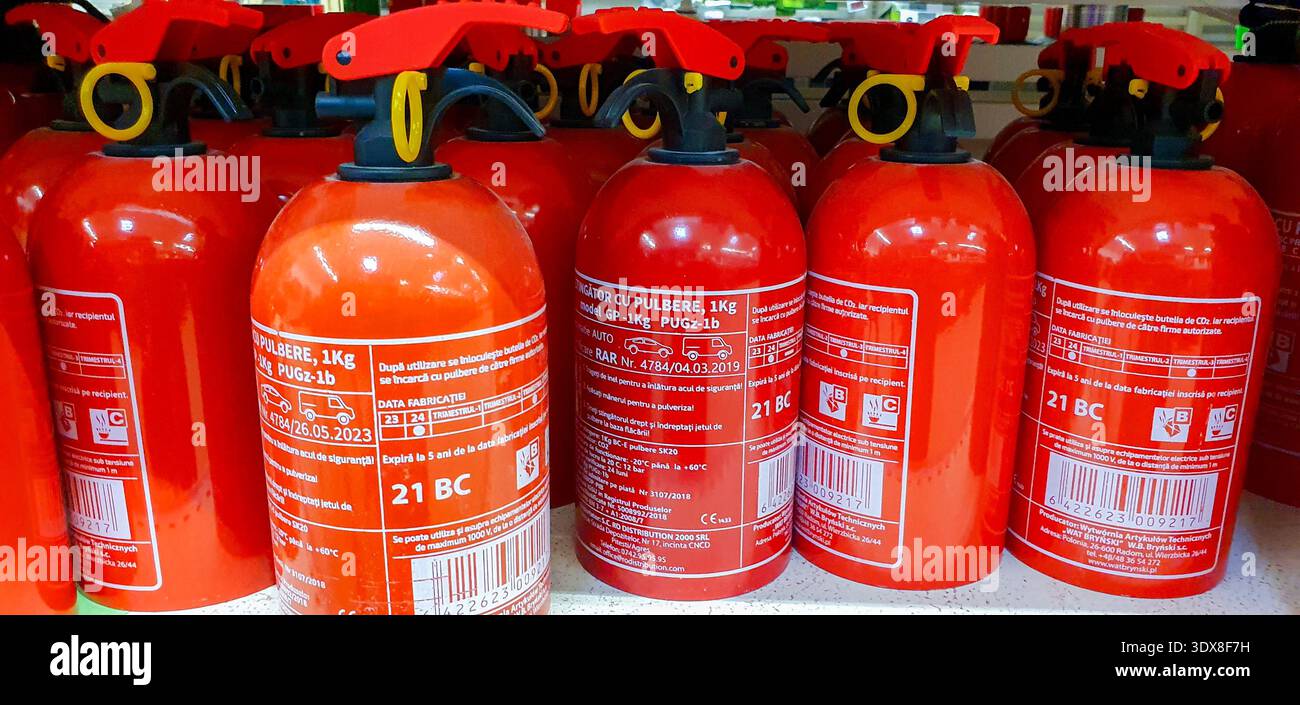 Red fire extinguishers in a store Stock Photo - Alamy