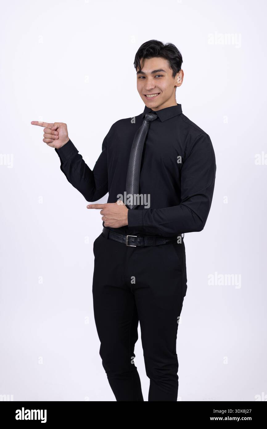 Man in black shirt pointing to the side Stock Photo