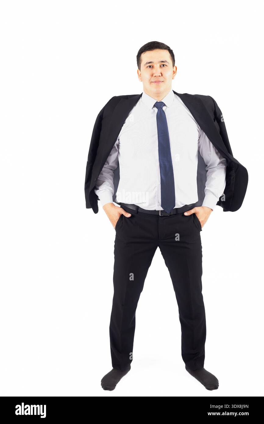 Confident businessman standing with hands in pockets Stock Photo