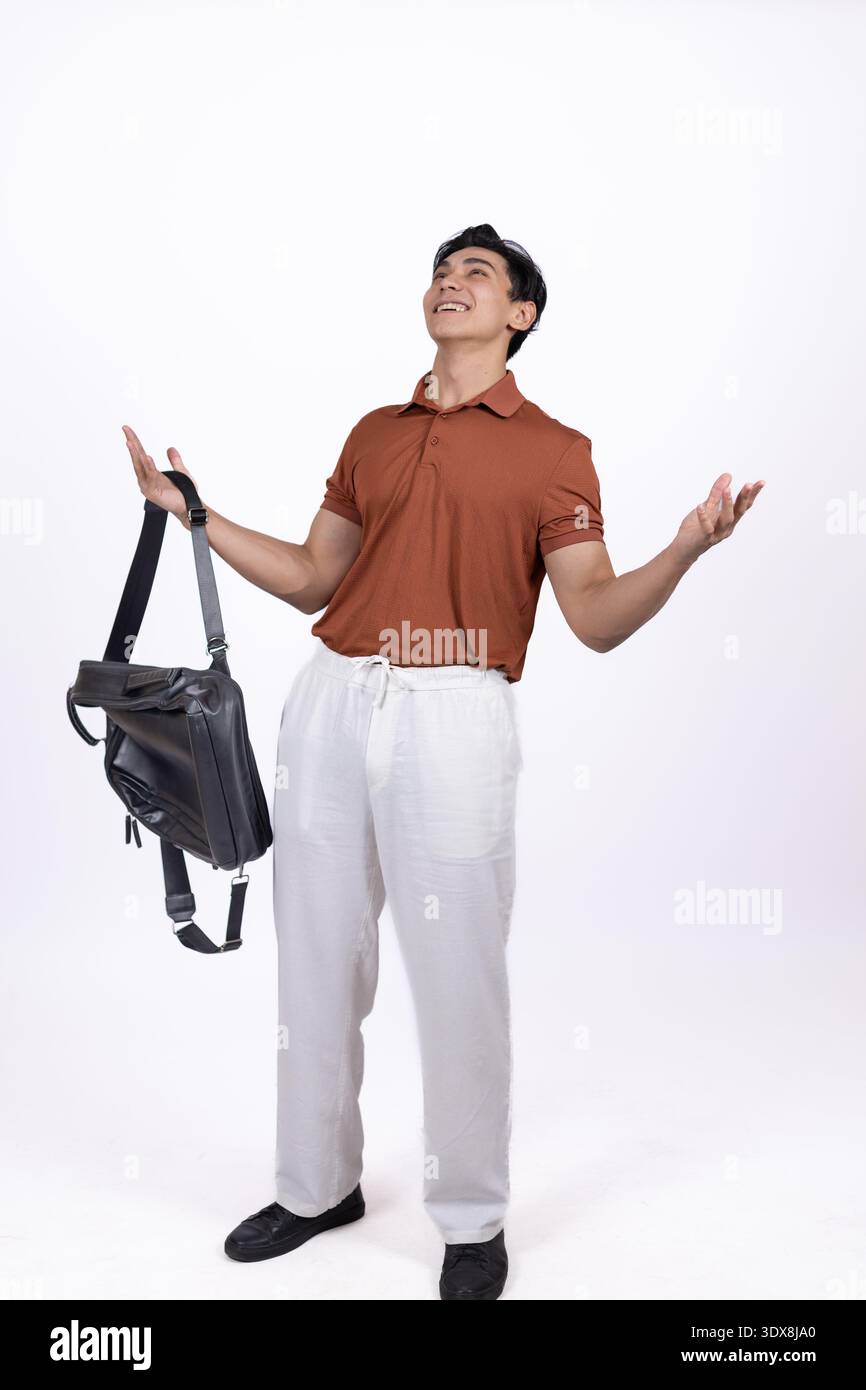 Young man holding a black bag or backpack Stock Photo