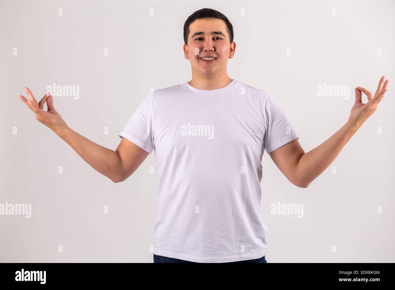 Man gesturing with open hands on white background Stock Photo